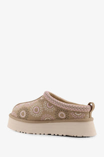 Beige ugg women’s tazz suede slip-on sandals with embroidered floral pattern and textured knit trim