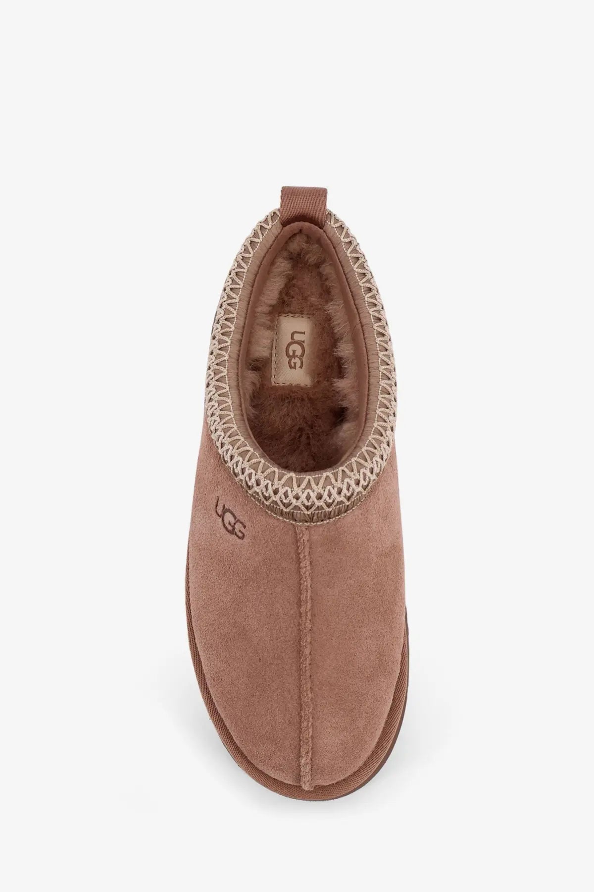 Ugg women’s tazz beige suede slipper with cozy plush interior and decorative braided trim around the opening