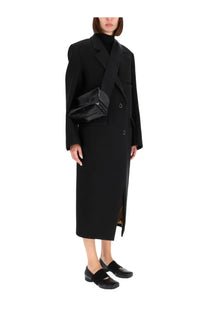 Black glossy patent leather crossbody bag with structured rectangular shape and minimalist silver hardware for women