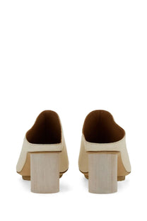 Cream-colored leather mules with wooden block heel by uma wang womens leather mule white shown from the back