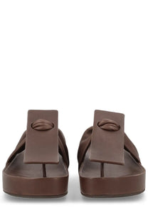 Uma wang women’s brown leather flip-flops with embossed lip design on distinctive rectangular strap
