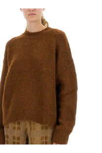 A cozy rust-colored mohair wool blend sweater by Uma Wang with soft fuzzy texture and relaxed fit for women