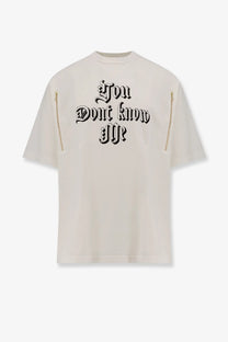 Undercover men’s cotton cream oversized t shirt with black gothic lettering and gold zippers on sleeves