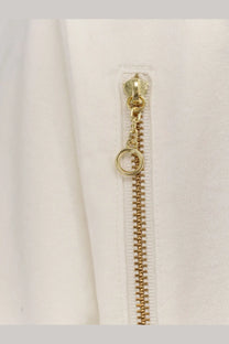 Undercover men’s cotton shirt white with gold-toned zipper and circular pull tab on white fabric garment