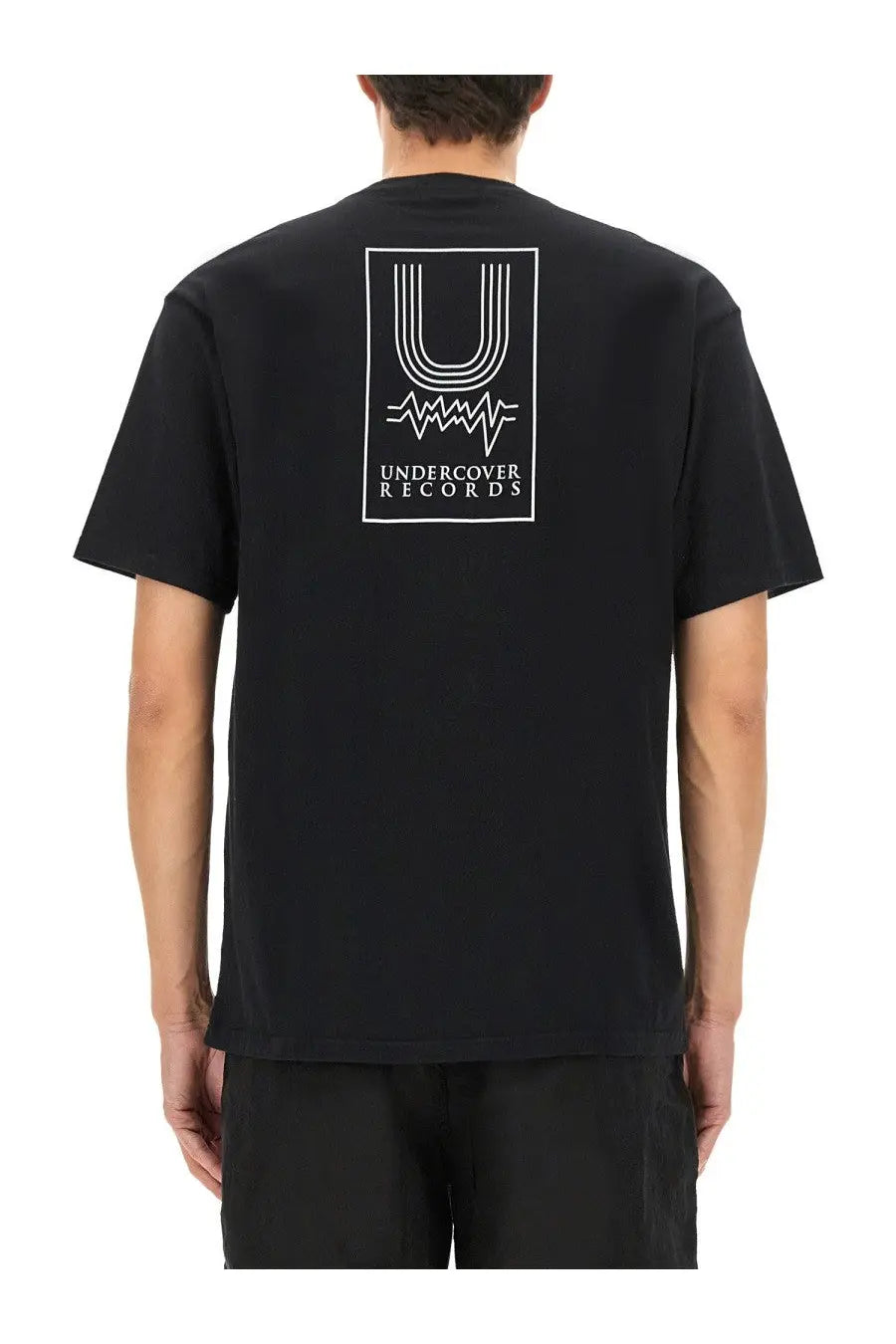 Undercover men’s black short-sleeved t-shirt with white rectangular undercover records logo and graphic elements