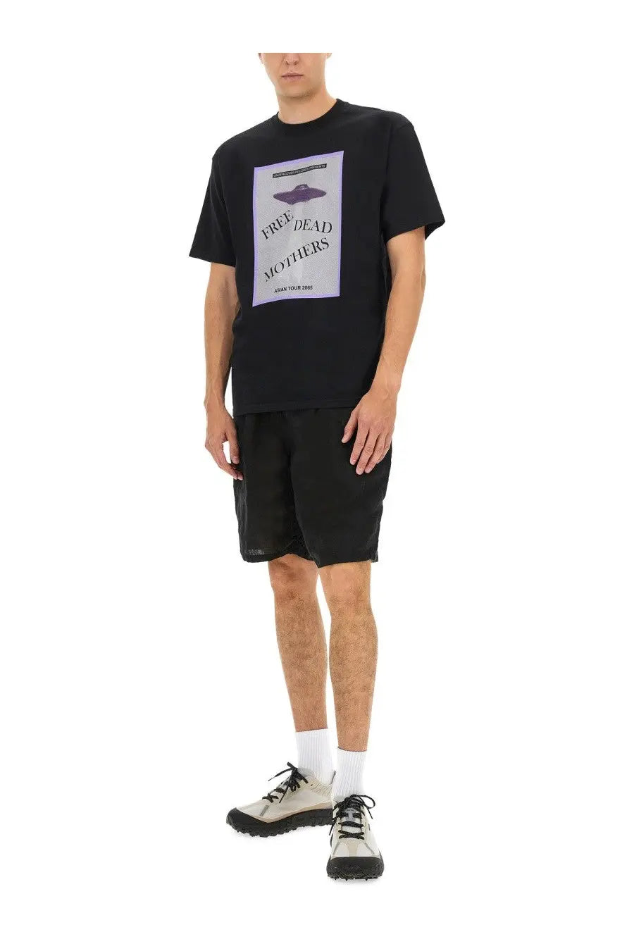 Undercover men’s black t-shirt featuring a purple UFO graphic and white text reading free dead mothers on front