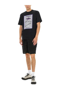 Undercover men’s black t-shirt featuring a purple UFO graphic and white text reading free dead mothers on front