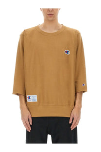 Undercover unisex tan champion sweatshirt with classic crew neck three quarter sleeves and embroidered logos
