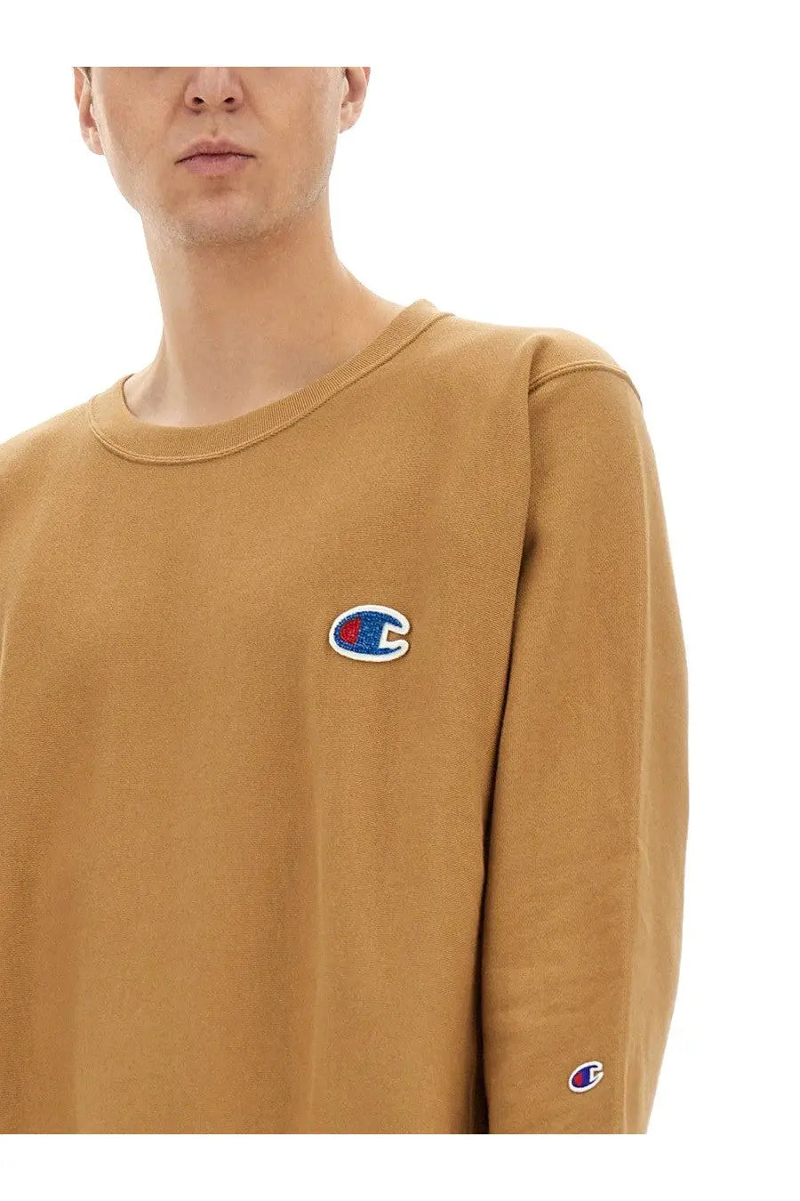 Tan unisex champion sweatshirt with beige embroidered logo on chest and sleeve in cotton blend fabric