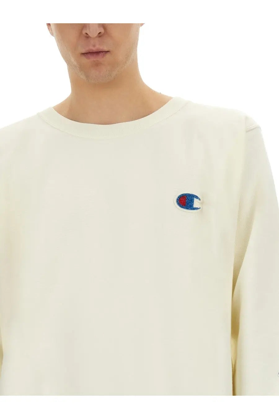 Cream-colored unisex champion sweatshirt with embroidered logo on left chest from undercover shirt white collection