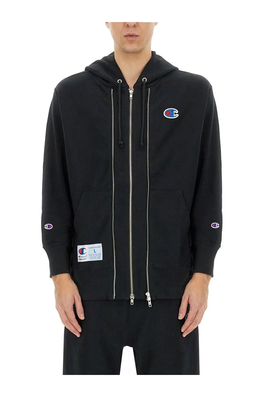 Black champion zip-up hoodie with silver zippers and embroidered logos from undercover unisex sweatshirt collection