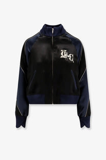 Undercover women’s satin bomber jacket in black and navy with white embroidered logo on the chest