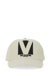 Cream-colored Valentino men’s embroidered baseball cap with bold black v logo and chez valentino paris rome text