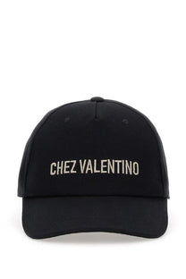 Black baseball cap with chez valentino embroidered in white thread across the front by Valentino men’s collection