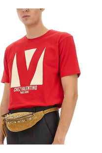 Valentino men’s red cotton t-shirt with cream geometric logo and white text featuring chez valentino design