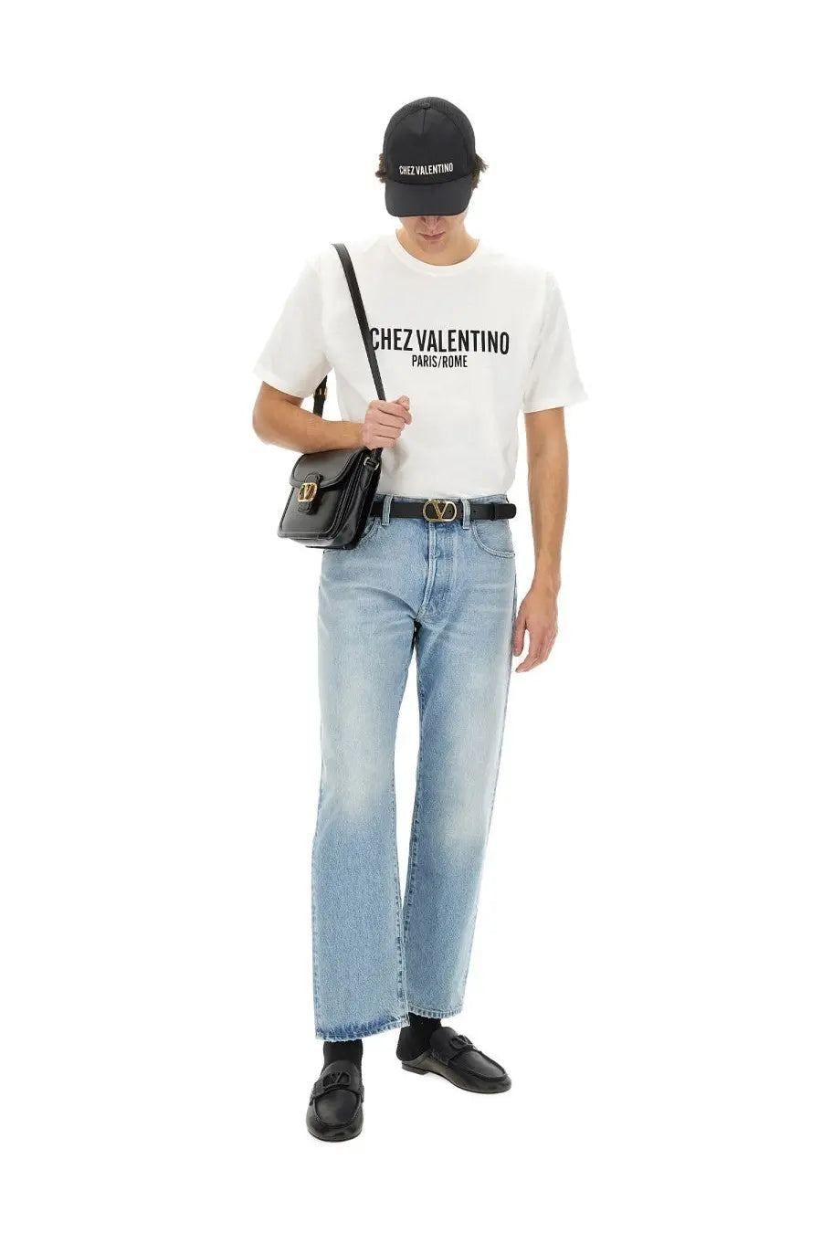 Black leather crossbody bag with gold-tone v-logo buckle paired with valentino men’s white cotton shirt