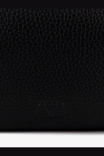 Black textured leather Valentino men’s clutch with embossed Valentino Garavani logo in a sleek black finish