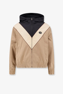Valentino men’s black hooded jacket with beige v-shaped color block design and elastic cuffs and hem