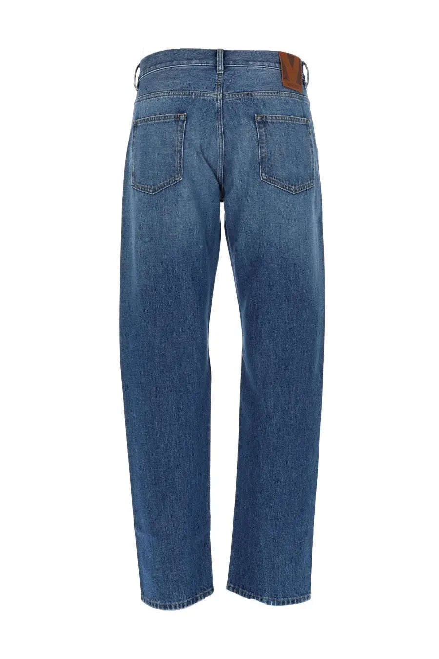 Valentino men’s jeans cinque tasche in denim blue showing back with brown leather brand patch on waistband