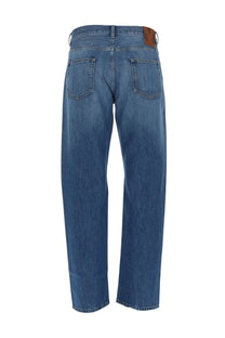 Valentino men’s jeans cinque tasche in denim blue showing back with brown leather brand patch on waistband