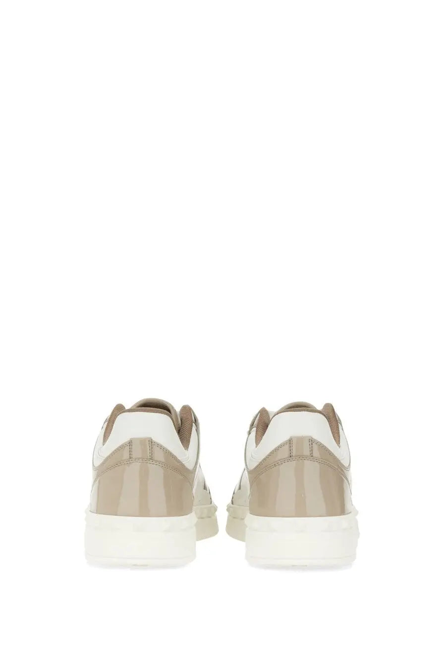 Beige and white valentino men’s low top sneakers with glossy heel counter in a back side view