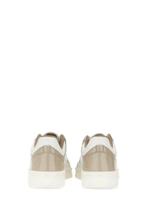 Beige and white valentino men’s low top sneakers with glossy heel counter in a back side view