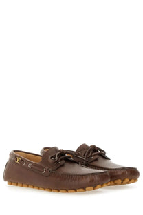 Valentino men’s brown leather loafers with classic moccasin design tan rubber soles and gold-tone branding on side
