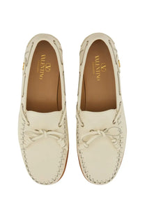 Valentino men’s palm avenue boat moccasin in cream leather with braided lace up design and gold branding insole