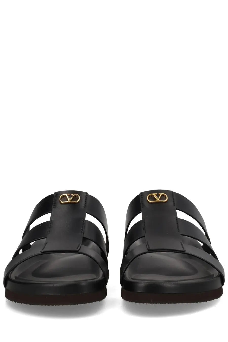 Valentino men’s Sandalo slide sandals in black leather with gold-tone v-logo hardware and studshield detail