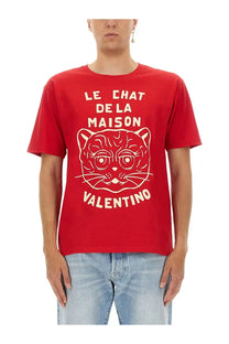 Valentino men’s red t-shirt with white outlined cat graphic and text le chat de la maison and valentino logo