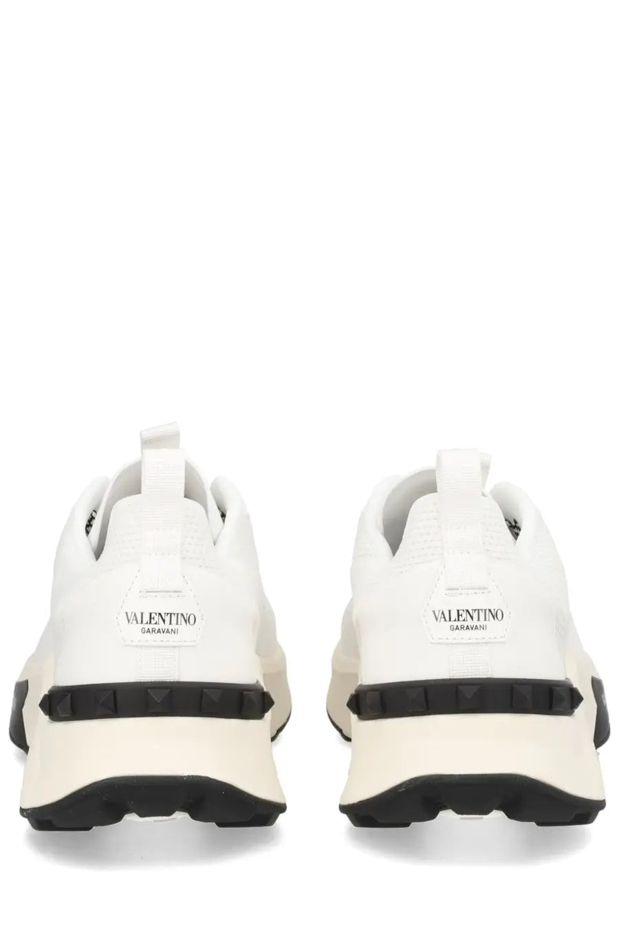 Valentino men’s sneaker true act white with black rubber soles and textured heel detail shown from the back side