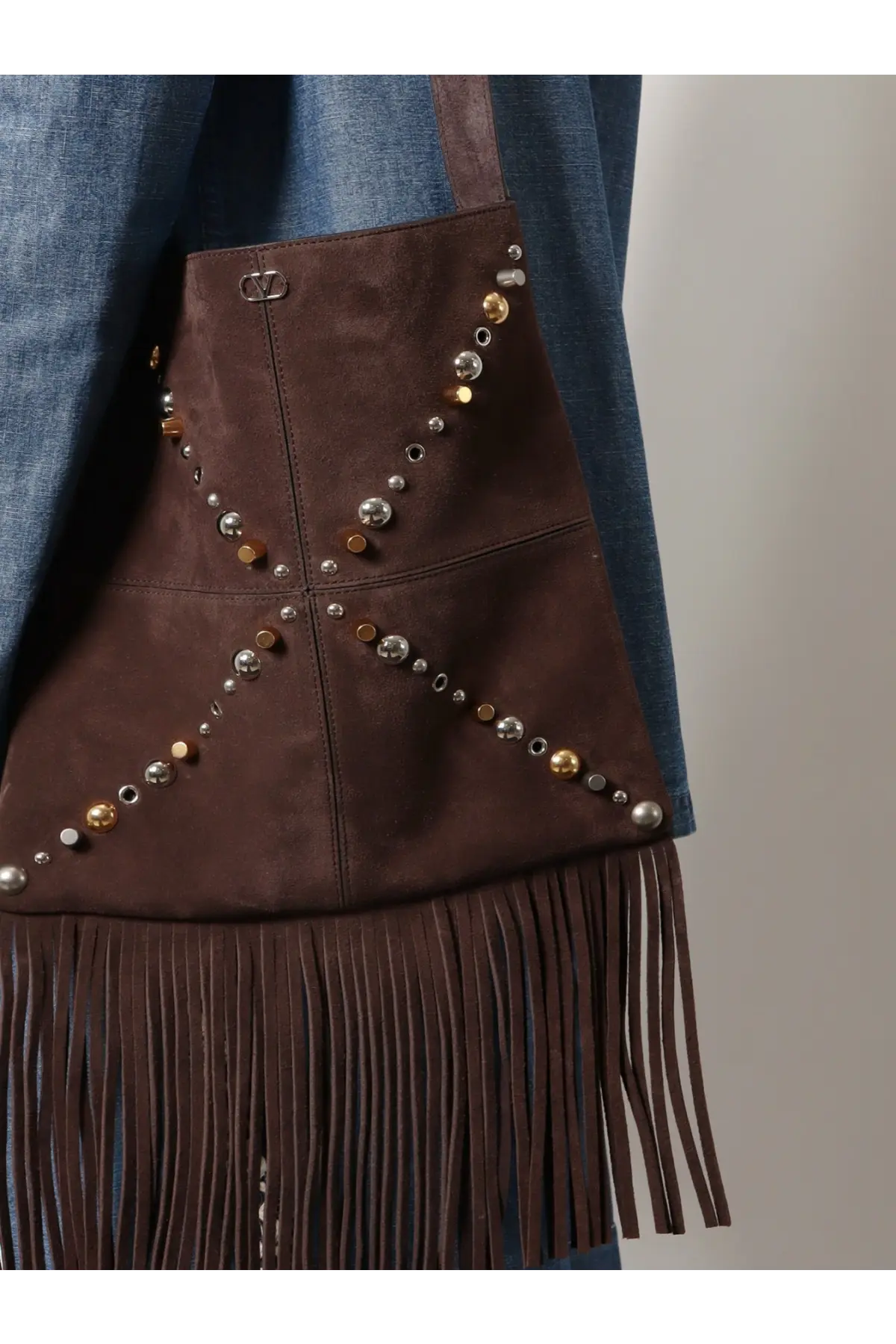 Valentino men’s brown suede shoulder bag with gold and silver studs and long fringe detailing at the bottom