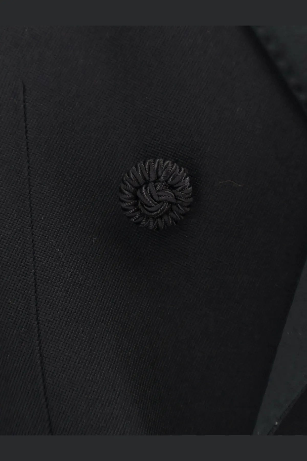 Black textured button with intricate woven design on valentino men’s virgin wool blazer black