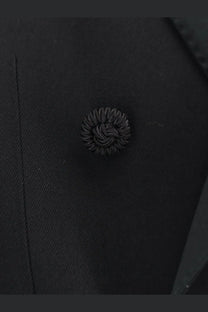 Black textured button with intricate woven design on valentino men’s virgin wool blazer black