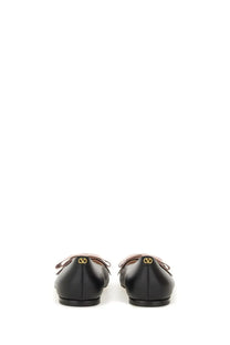 Valentino women’s ballerina bowow black leather flat shoes with bow detail and gold-tone logo at the heel back view