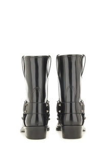 Valentino women’s black patent leather ankle boots with silver buckle straps and studded detailing