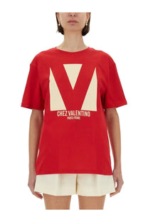 Valentino women’s red t-shirt with cream geometric v logo and chez valentino paris rome print on front