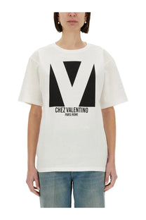 Valentino women’s white cotton t-shirt with bold black geometric v logo and chez valentino paris rome text print