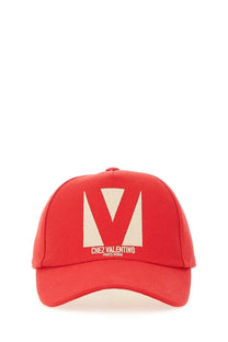 Valentino women’s red baseball hat featuring a bold cream v logo and chez valentino paris rome text beneath it