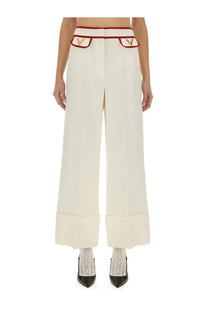 Valentino women’s crepe couture cream wide-leg trousers with red and gold trim and v-shaped logo waistband