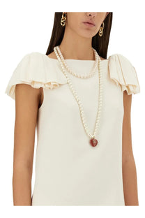 Valentino women’s crepe couture short dress white paired with a double-strand pearl necklace with red heart pendant