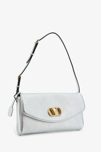 Valentino women’s devain laminated leather shoulder bag in silver with gold-tone logo clasp and black strap