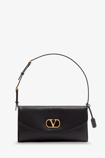 Valentino women’s Devain leather shoulder bag in black with gold-tone logo clasp and adjustable shoulder strap