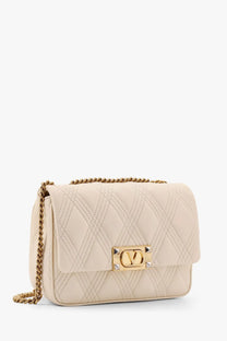Cream-colored quilted leather crossbody bag with gold-tone chain strap and signature logo clasp by Valentino