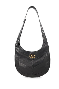 Valentino women’s hobo bag in black leather with gold-tone logo clasp and white polka dot strap detailing
