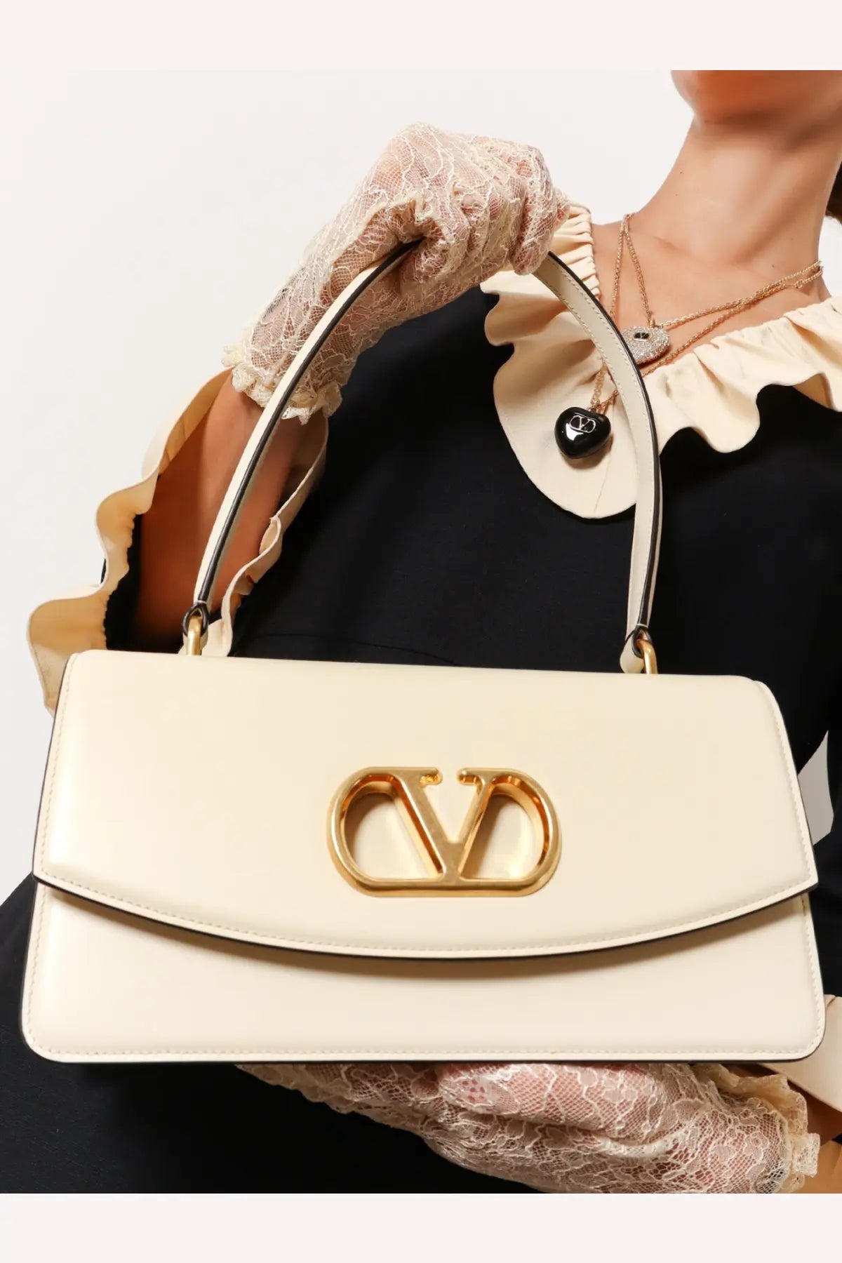 Cream-colored Valentino women’s leather shoulder bag with gold-tone Vlogo clasp in white leather