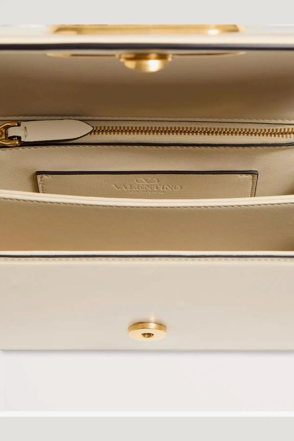 Cream-colored leather Valentino women’s Vlogo shoulder bag with gold-tone hardware and zippered interior compartment