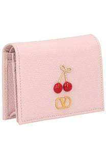 Pink leather Valentino women’s Portafoglio Cherryfic wallet with red cherry embellishment and gold-tone logo