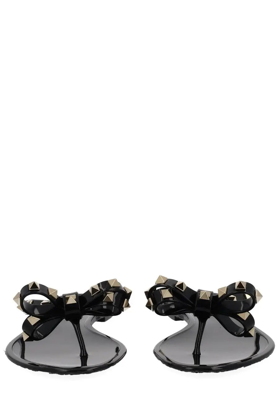 Valentino women’s black glossy flip-flops with gold-tone pyramid studs on a bow-adorned strap