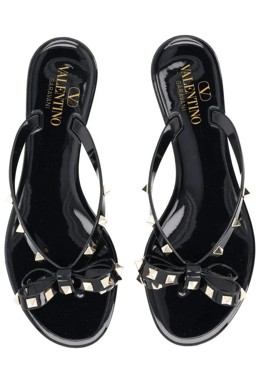 Valentino women’s black glossy leather Rockstud sandals with gold-tone pyramid studs and bow detail flip-flops